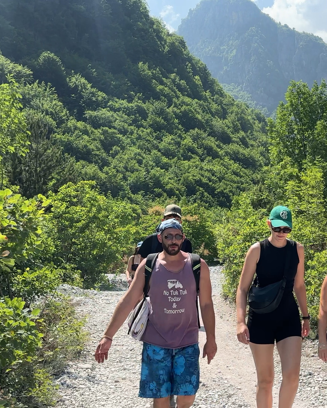 Funcle David leading a small group along a mountain trail in the Albanian Alps
