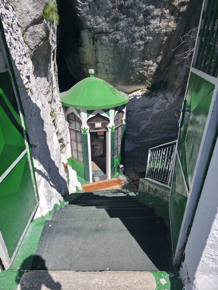 The green-domed shrine of Sari Salltik tucked inside the mountain cave